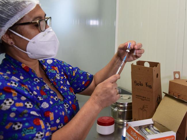 A health worker prepares a dose of the Russian Sputnik V coronavirus vaccine at the Itaugua National Hospital in Itagua, Paraguay, on February 22, 2021, amid the COVID-19 pandemic. - Last week, a first batch of 4,000 doses of Russian Sputnik V vaccines against COVID-19 arrived in Paraguay, with workers of respiratory therapy units the first to be immunized. (Photo by Norberto DUARTE / AFP)