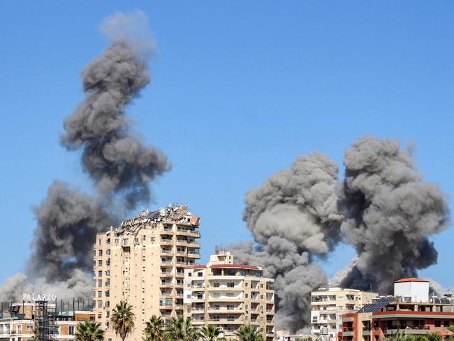 Smoke plumes erupt following an Israeli air strike on a neighbourhood of Lebanon's southern city of Tyre on October 23, 2024. Israel expanded operations in Lebanon nearly a year after Hezbollah began exchanging fire in support of its ally, Hamas, following the Palestinian group's deadly attack on Israel on October 7, 2023. (Photo by KAWNAT HAJU / AFP)