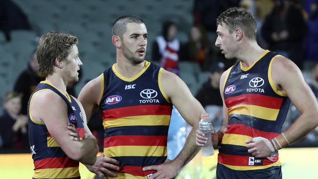 Rory Sloane, Taylor Walker and Daniel Talia in discussion after the Crows’ crushing near-miss against Melbourne. Picture: Sarah Reed