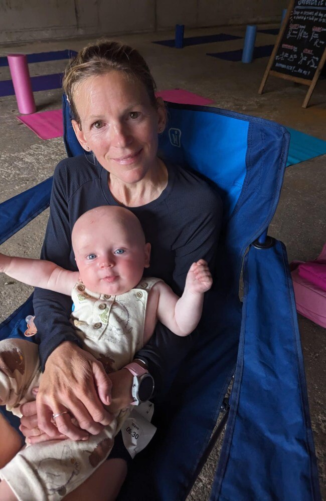 Sophie holding Teddy after her race. Picture: Caters News