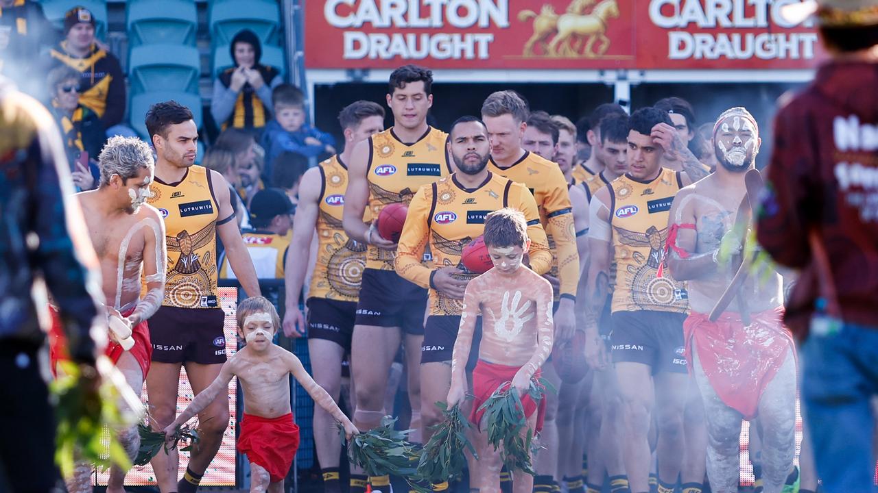 The Hawks walk onto the field. Picture: Dylan Burns/AFL Photos via Getty Images