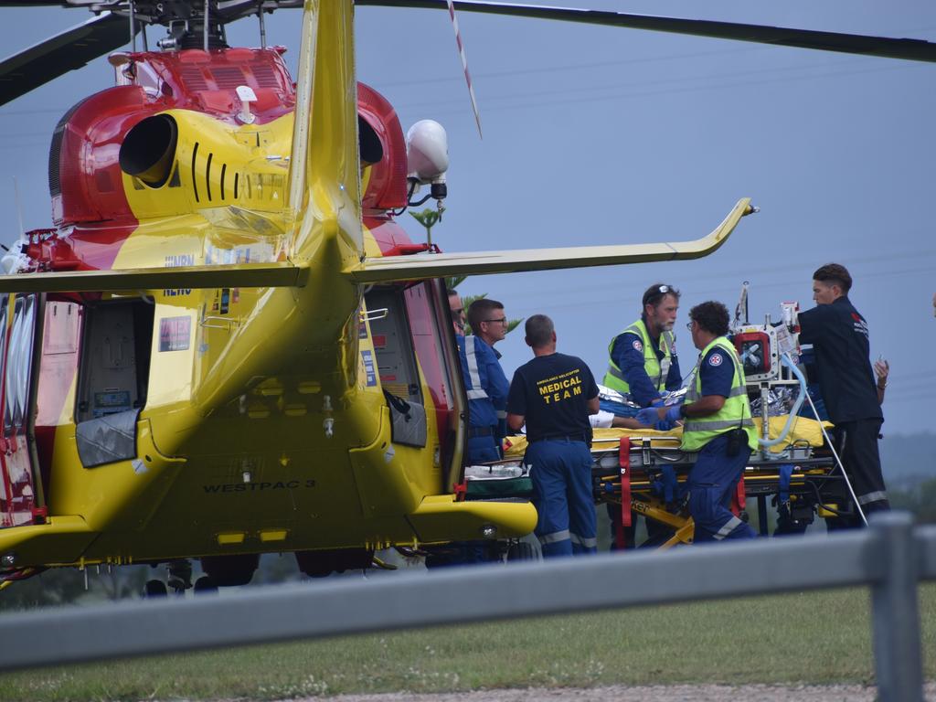 A man who suffered serious injuries after the red sedan Mitsubishi Lancer sedan he was driving crashed into a power pole on Rogans Bridge Rd north of Waterview Heights was transported by road ambulance to the Westpac Rescue Helicopter located in a nearby paddock on Thursday, 18th February, 2021. Photo Bill North / The Daily Examiner