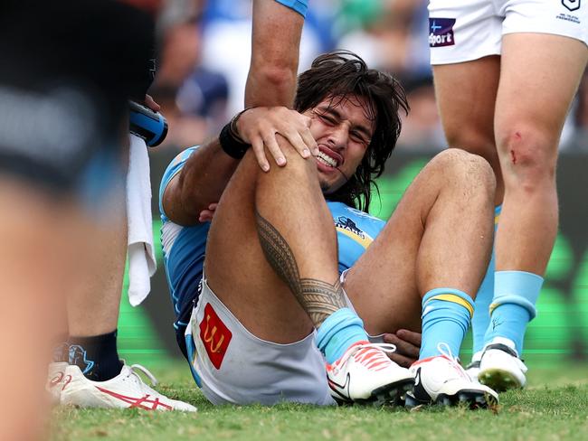 SYDNEY, AUSTRALIA - MARCH 23: Tino Fa'asuamaleaui of the Titans holds his leg after a tackle during the round three NRL match between Canterbury Bulldogs and Gold Coast Titans at Belmore Sports Ground, on March 23, 2024, in Sydney, Australia. (Photo by Brendon Thorne/Getty Images)