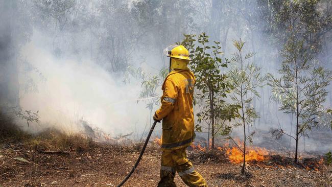 A firefighter works on a fire ground at Deepwater, north of Bundaberg. Picture: QFES via AP