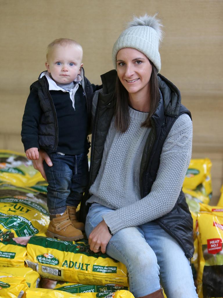 Treat yourself: Sarah Lines and Isaiah, 14 months, from Orroroo in South Australia, soak up the action. Picture Yuri Kouzmin