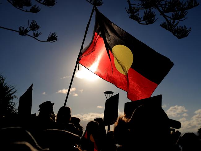 An Aboriginal flag flies over the Protest march and gathering at Byron BAy for Back Lives Matter. Photo Scott Powick Newscorp