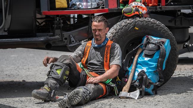 Gareth Desmond from Tree Crew takes a break at the CFS marshalling area at Oakbank Oval. Picture: Brad Fleet