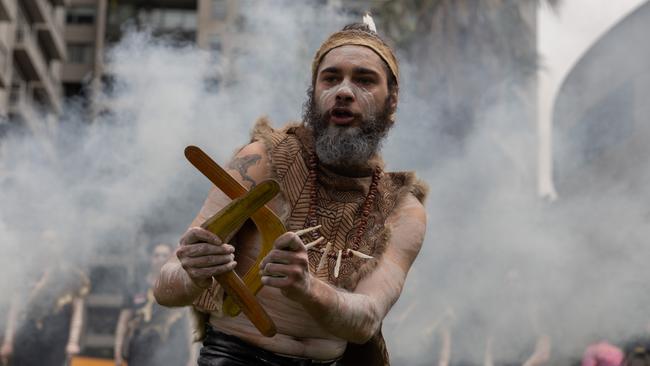 Indigenous performers perform the welcome to country during a smoke ceremony.