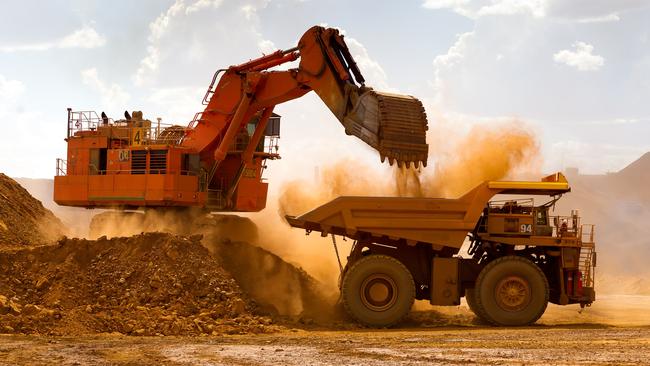 A haul truck is loaded by a digger with material from the pit at Rio Tinto Group's West Angelas iron ore mine. Picture: Ian Waldie