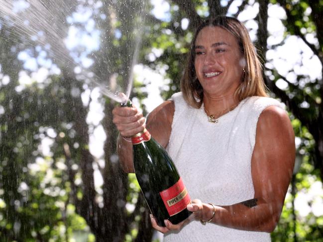 Belarus' Aryna Sabalenka opens a bottle of champagne as she celebrates with the 2024 Australian Open winner's trophy at Carlton Gardens in Melbourne on January 28, 2024, following her victory over China's Zheng Qinwen in the women's singles final of the tennis tournament. (Photo by David GRAY / AFP) / -- IMAGE RESTRICTED TO EDITORIAL USE - STRICTLY NO COMMERCIAL USE --