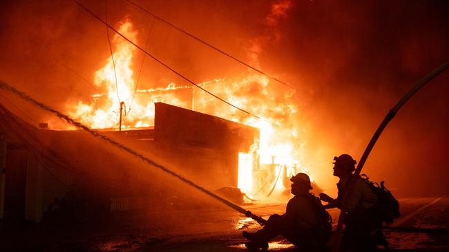 Firefighters battle winds and flames as multiple beachfront homes go up in flames along Pacific Coast Highway in Malibu in the Palisades Fire. Picture: Getty