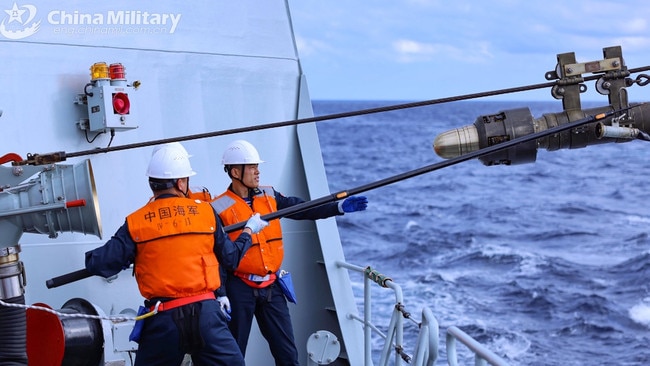 Two sailors aboard the guided-missile frigate Dali (Hull 553) during an emergency supply training exercise on February 1, 2025. Picture: eng.chinamil.com.cn/Cai Shengqiu