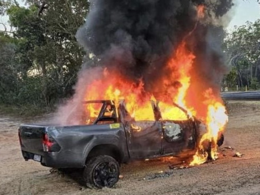 A car bursts into flames after being towed from the scene where it crashed into a home at Urangan.