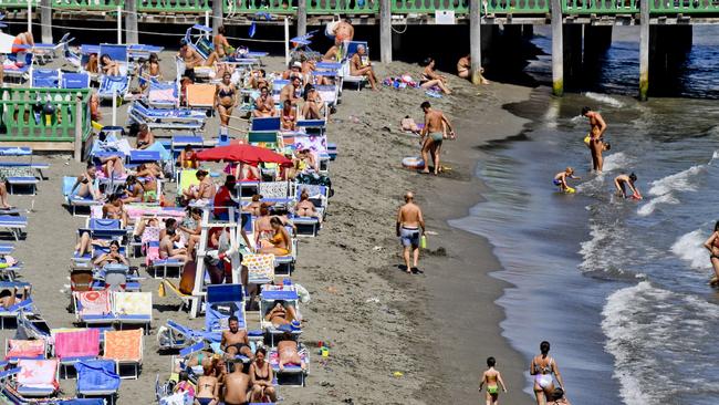 Authorities have reprimanded young adults for disregarding public-health rules such as at this beach in Posillipo, Naples, on Sunday. Picture: EPA