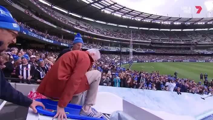 Andrew Gaze goes for an icy slide at the MCG