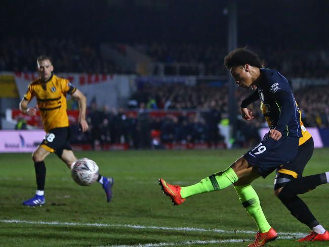Manchester City's German midfielder Leroy Sane hits the bar with this attempt during the English FA Cup fifth round football match between Newport County and Manchester City at Rodney Parade in Newport, south Wales on February 16, 2019. (Photo by GEOFF CADDICK / AFP) / RESTRICTED TO EDITORIAL USE. No use with unauthorized audio, video, data, fixture lists, club/league logos or 'live' services. Online in-match use limited to 120 images. An additional 40 images may be used in extra time. No video emulation. Social media in-match use limited to 120 images. An additional 40 images may be used in extra time. No use in betting publications, games or single club/league/player publications. /