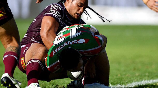 Manly prop Marty Taupau holds up South Sydney's Cameron Murray to save a certain try.