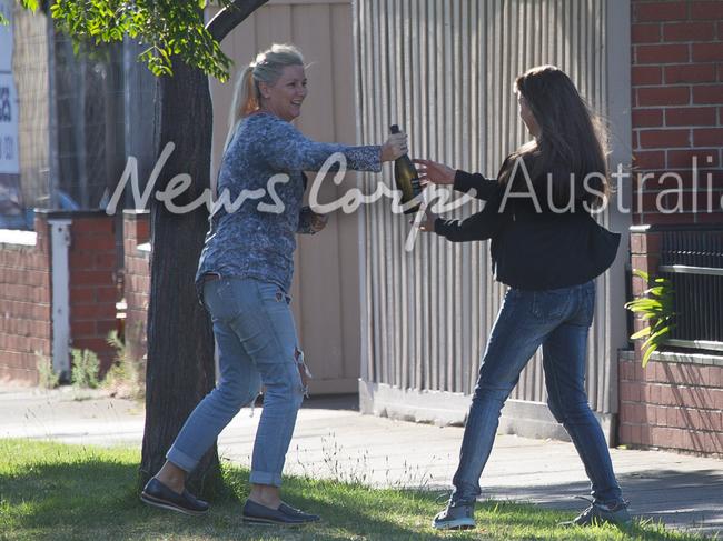 Tania Hyett and Yvette Nikolic looked to be in party mode outside the Port Melbourne house. Picture: Matrix for News Corp Australia 