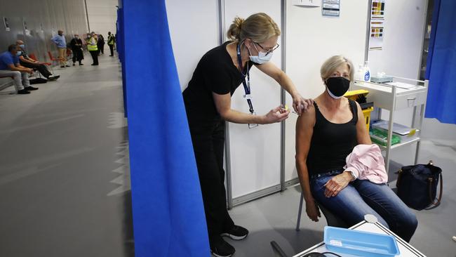 Louise Boulanger is injected with the Astrazeneca vaccine by nurse Chris Bergin. Picture: David Caird