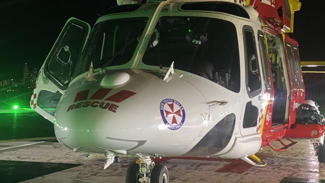 Westpac Lifesaver Rescue Helicopter at Lismore base readying to fly a man in his late teens to the Gold Coast University Hospital with serious head and chest injuries.