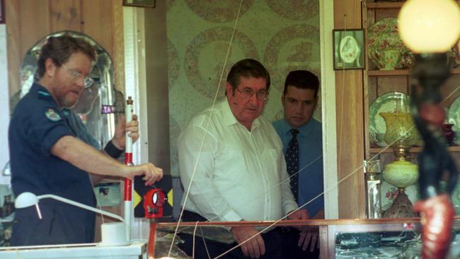 Paul Visentin (centre) at his shop after the shooting. Picture: David Clark