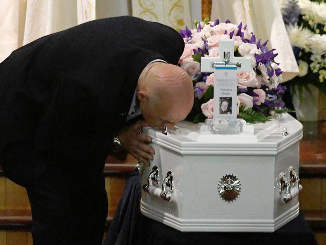 Bob Sakr kisses the coffin of his daughter Veronique Sakr, 11, during her funeral at the Santa Sabina College Chapel in Sydney, Tuesday, February 11, 2020. Veronique Sakr was hit and killed together with three of her cousins by an alleged drunk driver in Oatlands, in Sydney's west. (AAP Image/Bianca De Marchi) NO ARCHIVING