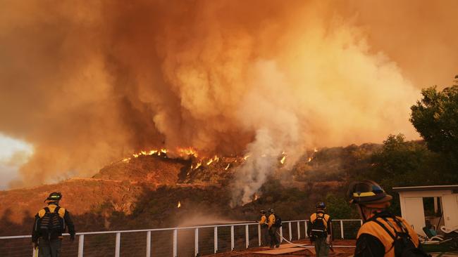 Fire crews monitor the Palisades Fire in Mandeville Canyon on Saturday, Jan. 11, 2025, in Los Angeles. (AP Photo/Jae C. Hong)