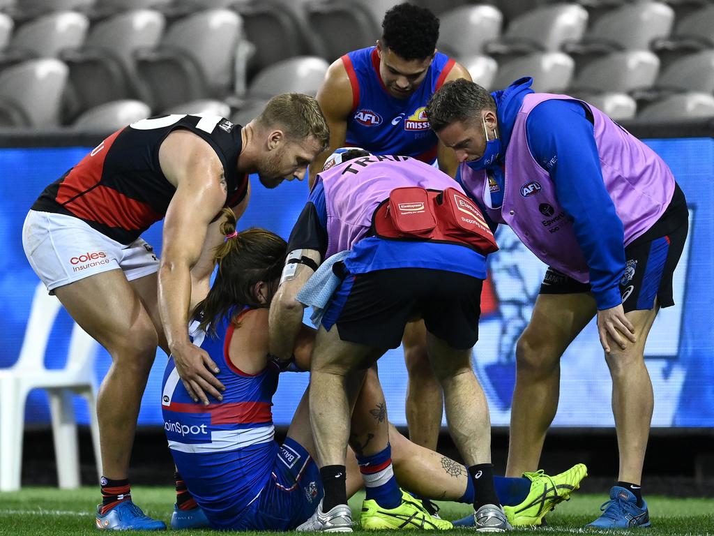 Essendon’s Jake Stringer was among those to assist Bruce after he was struck down by injury. (Photo by Quinn Rooney/Getty Images)