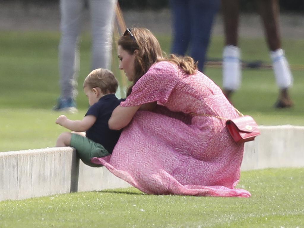 Britain's Kate, Duchess of Cambridge and Prince Louis play on the grass. Picture: Andrew Matthews/PA via AP.