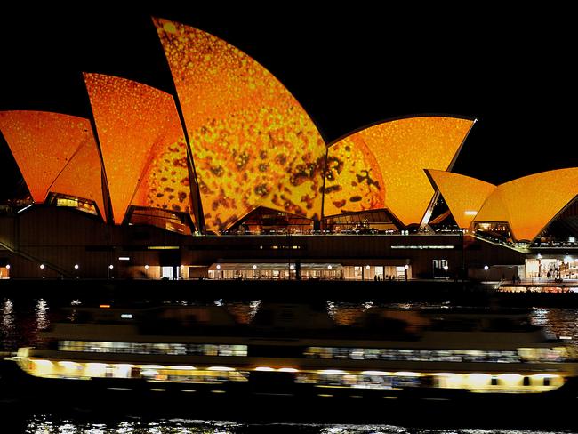 A ferry moves past the Sydney Opera House, illuminated with light art by Brian Eno at the first Vivid Sydney in 2009. Picture: Greg Wood / AFP