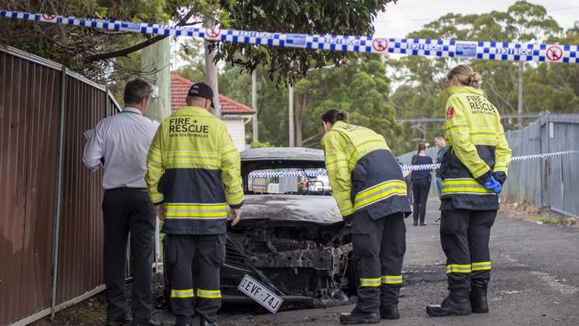 The suspected getaway car lies burnt out at Birrong train station. Picture: NCA NewsWire