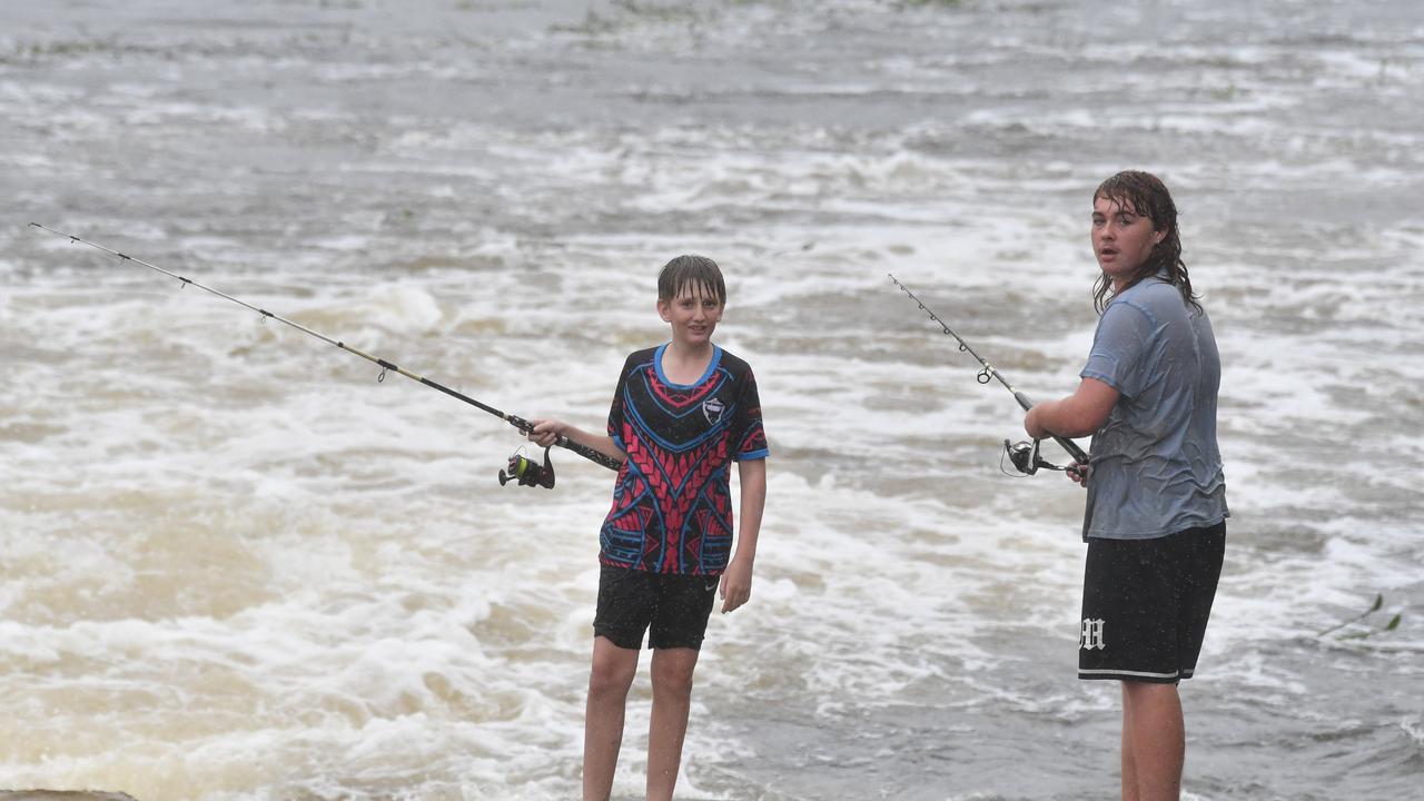 Wet weather in Townsville. Heavy rain does not stop fishing at Applins Weir. Picture: Evan Morgan