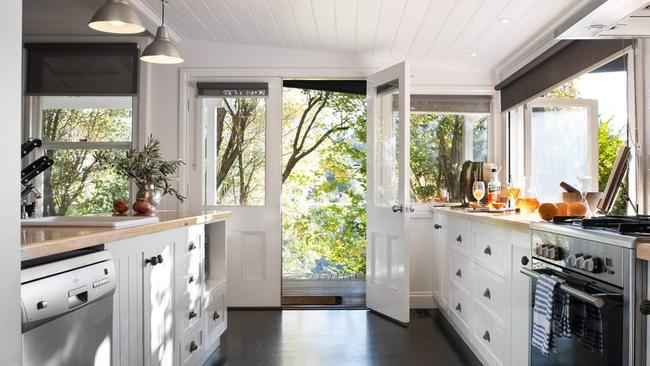 This country-style kitchen has French doors and sliding windows.