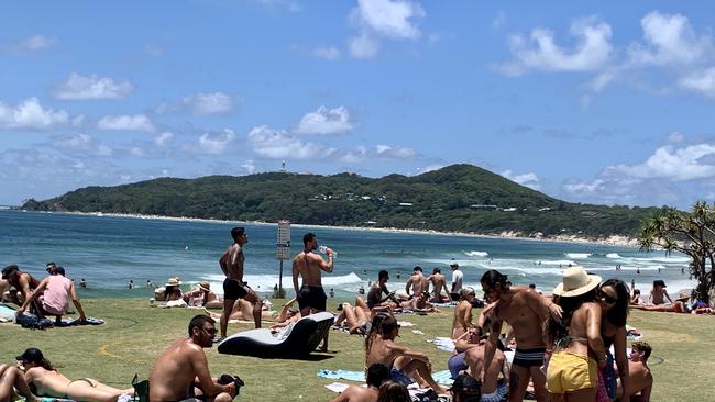 Tourists enjoy the sunny weather at Byron Bay.