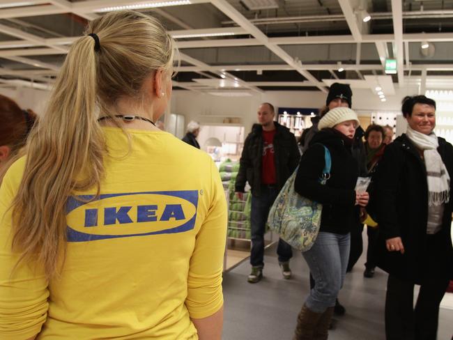 (FILE PHOTO) The IKEA group are set to cut 7,500 jobs over the next few years from administrative staff in central support. However they plan to create 11,500 new jobs during this period as they expand new store formats and their online business. BERLIN, GERMANY - DECEMBER 13:  An Ikea employee watches customers shopping during a store opening at the 4th Ikea chain store in Berlin Lichtenberg on December 13, 2010 in Berlin, Germany. Ikea, a Swedish furniture and household goods company now has 46th chain stores in Germany, including the newly opened one in Berlin Lichtenberg, which is the biggest one in Germany.  (Photo by Andreas Rentz/Getty Images)