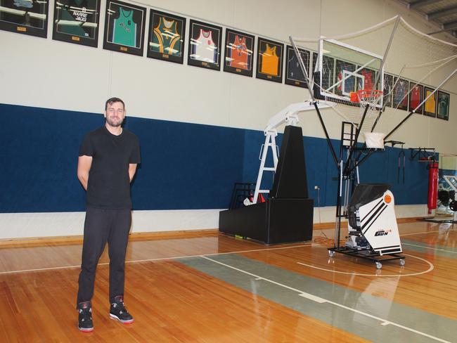 Bogut stands proudly inside his personal basketball gym.