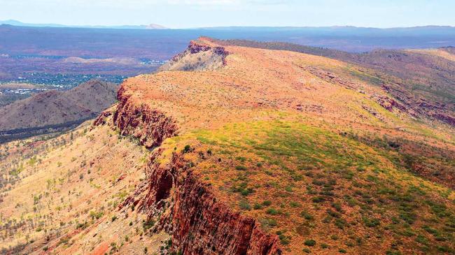 The view during a chopper ride in Alice Springs; right, one of the first cells used by prisoners at Fremantle Prison. The basins in later cells were removed as they became disease-ridden; and the typical tourist shot of the Sydney Harbour Bridge. Picture: Ellen Hanwright