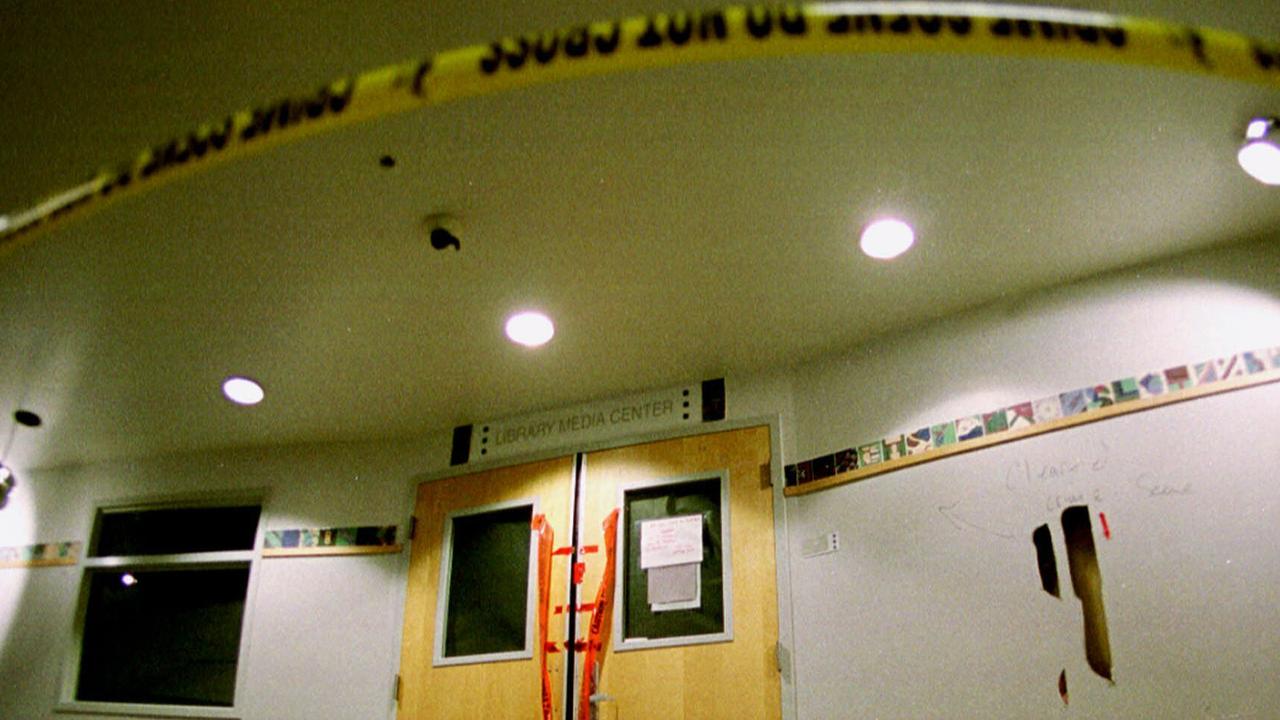 June 15, 1999: Tape marks the line in front of the doors to the library in Columbine High School as members of the media took their first trip through the school after the massacre. Picture: AP 