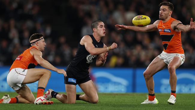 Adam Cerra finds a way past Toby Greene and Stephen Coniglio. Picture: Michael Klein