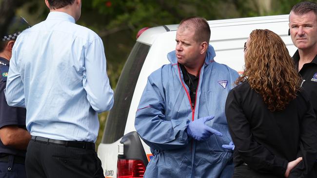 Wayne Heneker surrounded by police. Photo: Adam Head