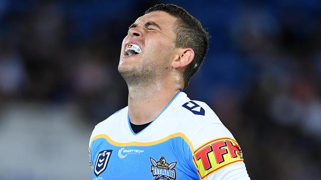 Ashley Taylor grimaces after sustaining an injury. Picture: AAP Image/Dave Hunt