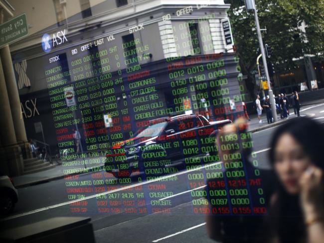 Pedestrians are reflected in a window as they walk  past an electronic stock board at the ASX Ltd. exchange centre in Sydney, Australia, on Thursday, Feb. 14, 2019. âWe made good progress on our core initiatives across the period, including the program to replace CHESS with distributed ledger technology; upgrade of our secondary data centre to strengthen market resilience; and restructure of our Listings Compliance team to enhance the quality of market oversight,â ASX Chief Executive Officer Dominic Stevens said. Photographer: David Moir/Bloombergrket resilience; and restructure of our Listings Compliance team to enhance the quality of market oversight,â ASX Chief Executive Officer Dominic Stevens said. Photographer: David Moir/Bloomberg