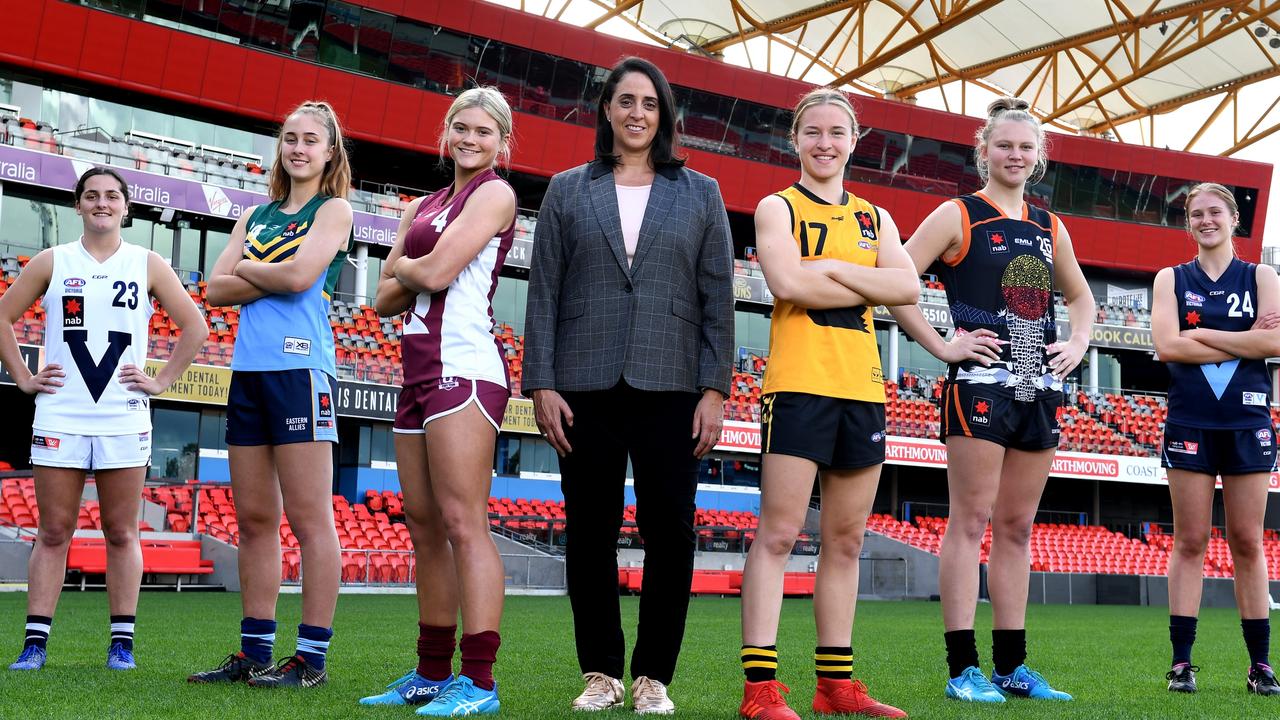 Georgia Garnett (second from left) and Lily Postlethwaite (third from left) have had an unorthodox journey to Aussie rules.