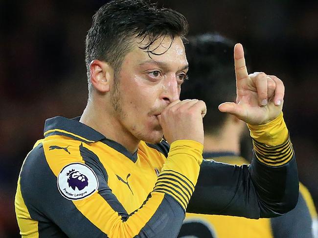 Arsenal's German midfielder Mesut Ozil gestures as he celebrates scoring his team's second goal during the English Premier League football match between Middlesbrough and Arsenal at Riverside Stadium in Middlesbrough, northeast England on April 17, 2017. / AFP PHOTO / Lindsey PARNABY / RESTRICTED TO EDITORIAL USE. No use with unauthorized audio, video, data, fixture lists, club/league logos or 'live' services. Online in-match use limited to 75 images, no video emulation. No use in betting, games or single club/league/player publications.  /