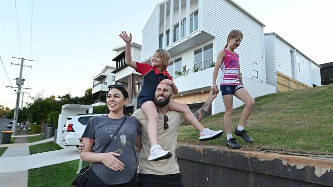 Cassie and Cameron Sawyer with two of their children, Peyton, 9, and Cami, 7, at their Clayfield home in Brisbane. Picture: Lyndon Mechielsen