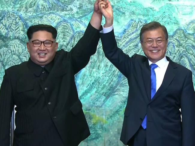 North Korea's leader Kim Jong Un and South Korea's President Moon Jae-in join hands near the end of their historic summit at Panmunjom. Picture: AFP PHOTO/KOREAN BROADCASTING SYSTEM (KBS)