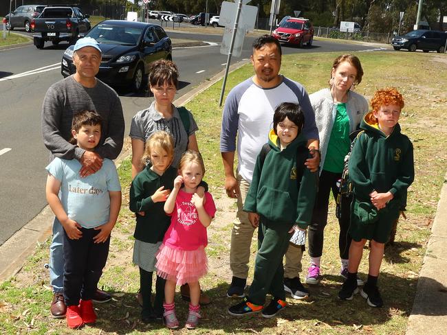 Torquay College parents and students (from left) Ryan Brinkworth and Owen, 8, Bridget Bond with daughters Frances, 7 and Edie, 5, Mit Kalayaboon and Mylo, 10, and Sarah Badelow and Louis, 9, at the busy Eton Rd unmanned crossing. Picture: Alison Wynd