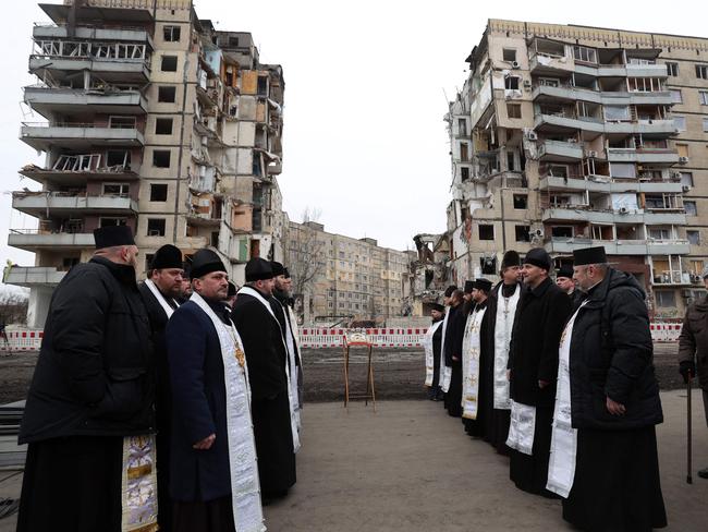 Orthodox priests hold a religious service in front of the residential building in the Ukrainian city of Dnipro, destroyed as a result of a missile strike. Picture: AFP