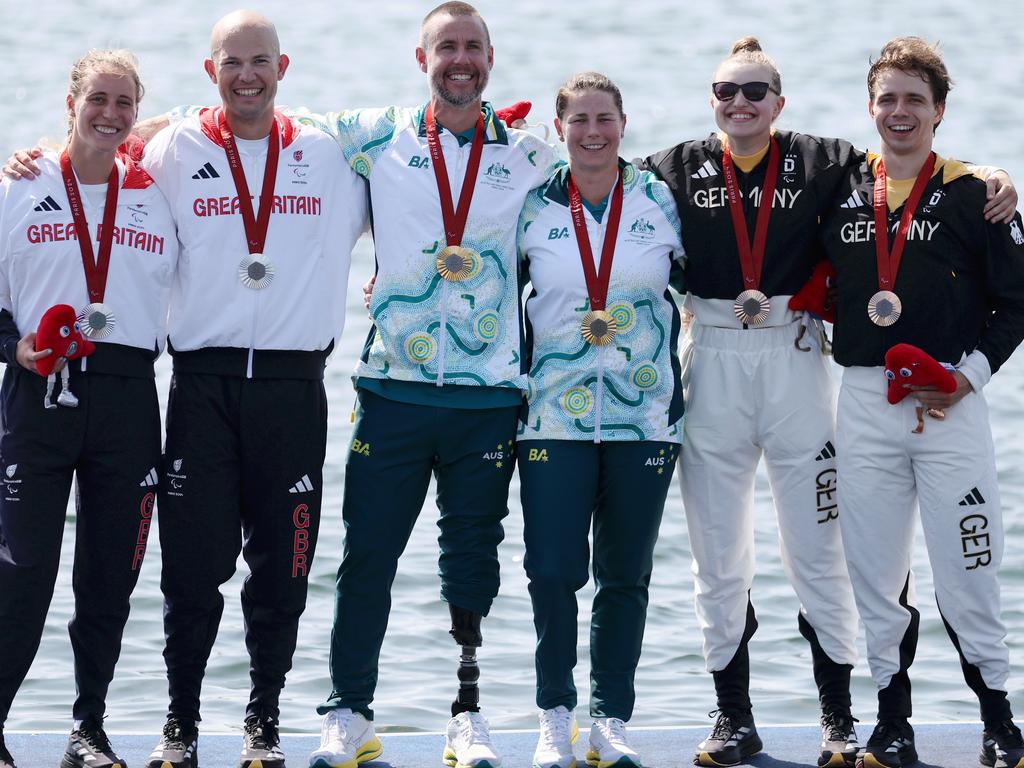 Gold medalists Nikki Ayers and Jed Altschwager on the dais alongside Team Great Britain and Team Germany. Picture: Naomi Baker/Getty Images