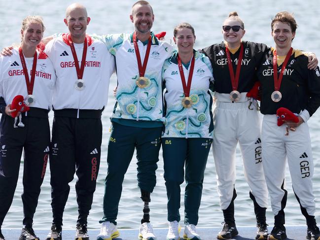 Gold medalists Nikki Ayers and Jed Altschwager on the dais alongside Team Great Britain and Team Germany. Picture: Naomi Baker/Getty Images